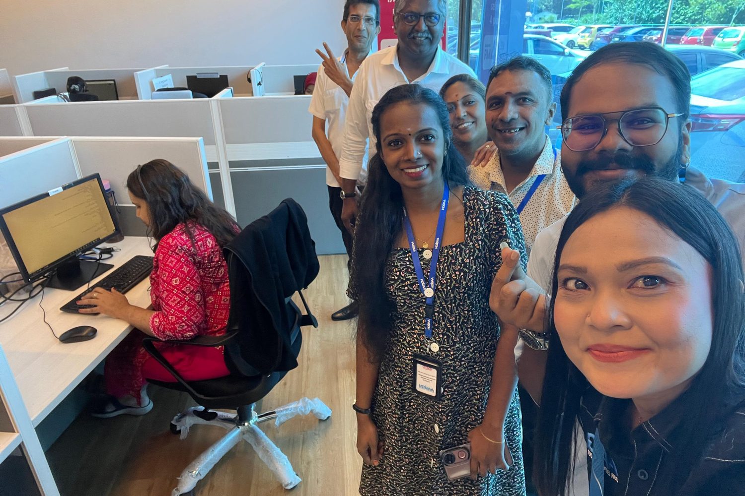 Team members taking a group selfie on the new floor